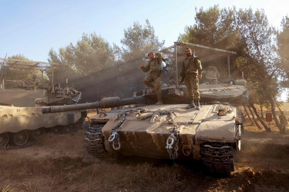 Israeli soldiers get down from their tank after returning from the Gaza Strip, in an area of Israel's southern border with the Palestinian territory on June 5, 2024, amid the ongoing conflict between Israel and the Palestinian group Hamas. — AFP pic