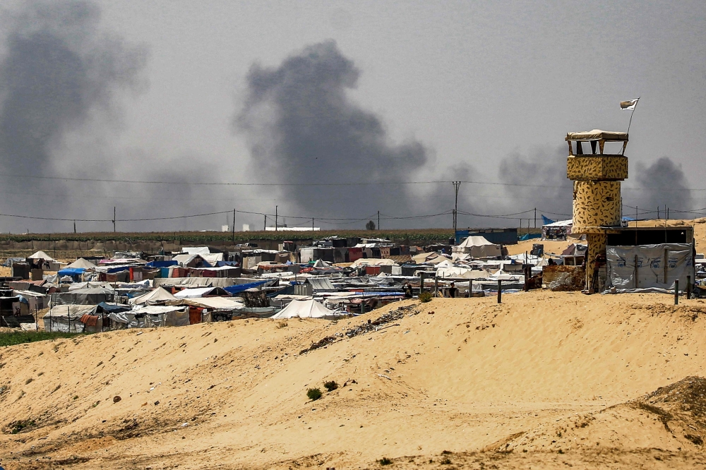 Smoke plumes billow near tents sheltering displaced Palestinians in Rafah in the southern Gaza Strip on June 4, 2024 amid the ongoing conflict in the Palestinian territory between Israel and Hamas. — AFP pic