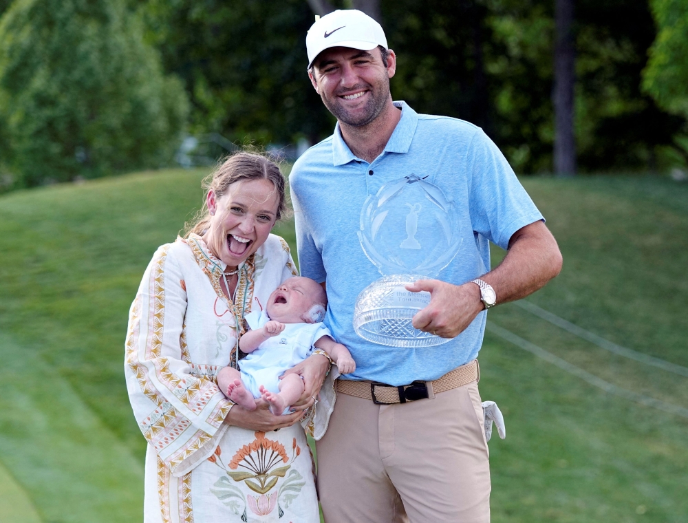 Scottie Scheffler and wife Meredith Scudder with Bennett Scheffler pose for a photograph with the trophy for the Memorial Tournament at Muirfield Village Golf Club in Dublin, Ohio June 9, 2024. — Picture by Adam Cairns-USA TODAY Sports via AFP