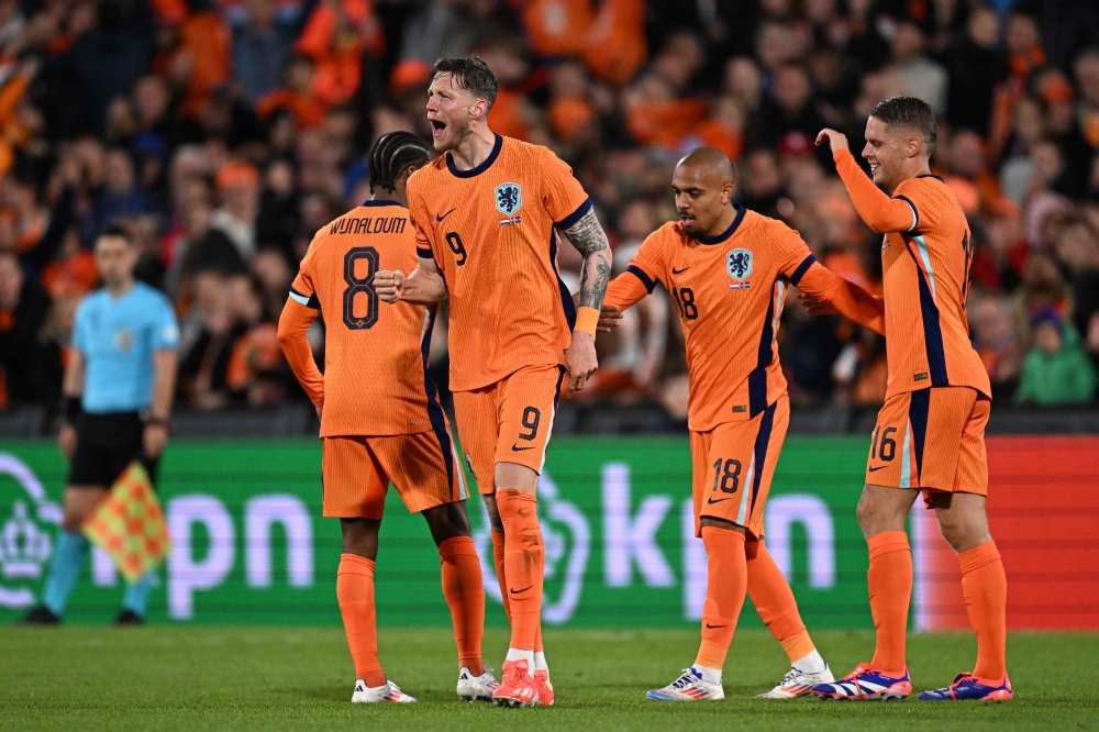 Netherlands' forward Wout Weghorst (second from left) celebrates after scoring his team's fourth goal during the International friendly football match between Netherlands and Iceland at the Feyenoord Stadium, in Rotterdam June 10, 2024. — AFP pic