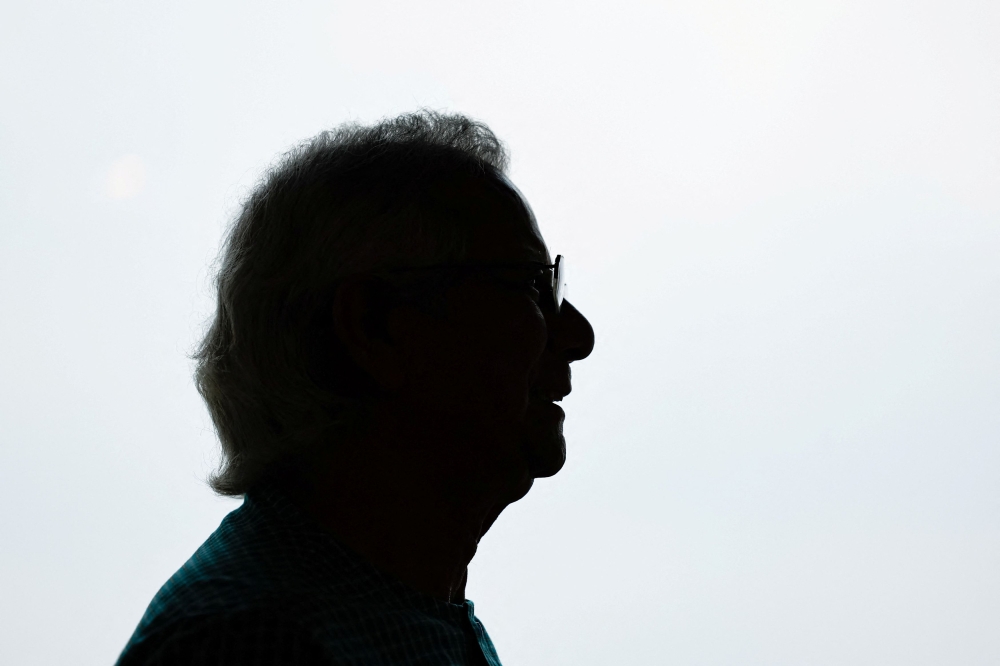 Bangladeshi Nobel peace prize winner Dr. Muhammad Yunus is silhouetted as he poses for a picture during an interview with Reuters in his office, in Dhaka June 4, 2024. — Reuters pic  