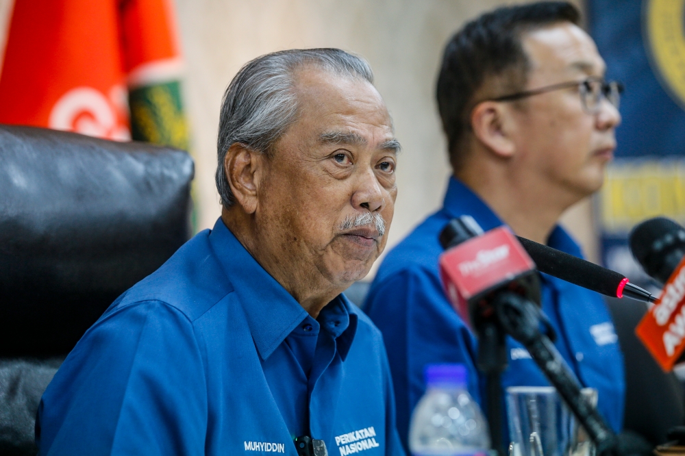 Tan Sri Muhyiddin Yassin (left) speaks to the media after the PN meeting last night, June 11, 2024. — Picture by Hari Anggara