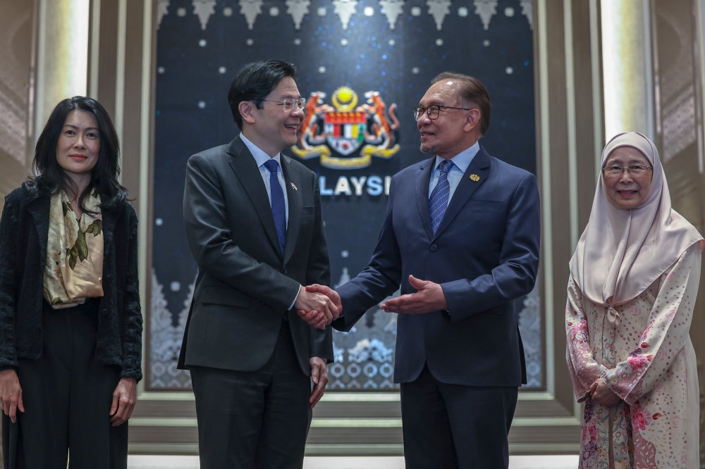 Prime Minister Datuk Seri Anwar Ibrahim and his Singapore counterpart Lawrence Wong post for pictures during a meeting in Putrajaya June 12, 2024. — Bernama pic