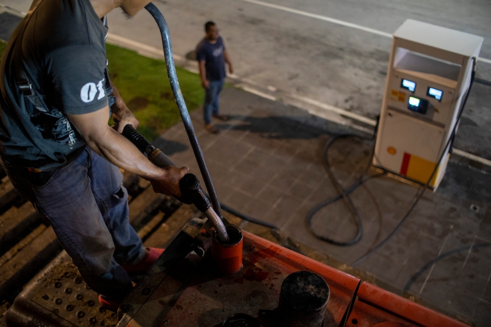 A man refuels diesel at a gas station in Telok Panglima Garang on June 9, 2024. — Picture by Shafwan Zaidon