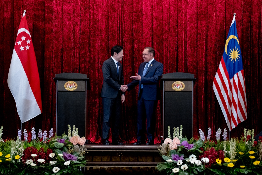 Prime Minister Datuk Seri Anwar Ibrahim with his Singapore counterpart Lawrence Wong during their public address, June 12, 2024. Anwar expressed hope that outstanding issues between Malaysia and Singapore can be resolved before their annual leaders retreat scheduled to take place at year’s end. — Picture by Sadiq Asyraf/Prime Minister’s Office of Malaysia  