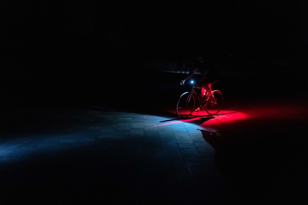 A cyclist rides his bike in non-illuminated street during a partial electricity blackout in Kyiv on June 6, 2024 following Russian strikes on Ukrainian energy infrastructure. — AFP pic