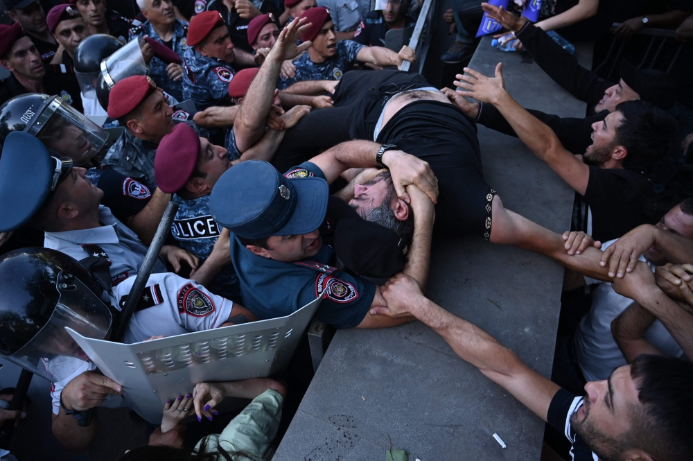 Dozens of demonstrators were injured in the Armenian capital Yerevan yesterday, after police fired stun grenades at an anti-government rally outside parliament, an AFP photographer witnessed. — AFP pic