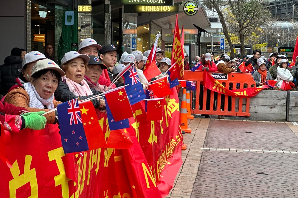 Members of the Chinese community gather to welcome Chinese Premier Li Qiang in Wellington today. — AFP pic