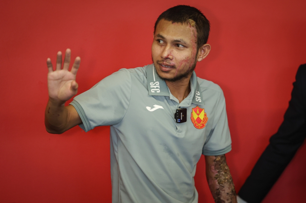 Faisal Halim waves to the media after making his first public appearance at the Selangor FC Training Centre, June 13, 2024. — Bernama pic 