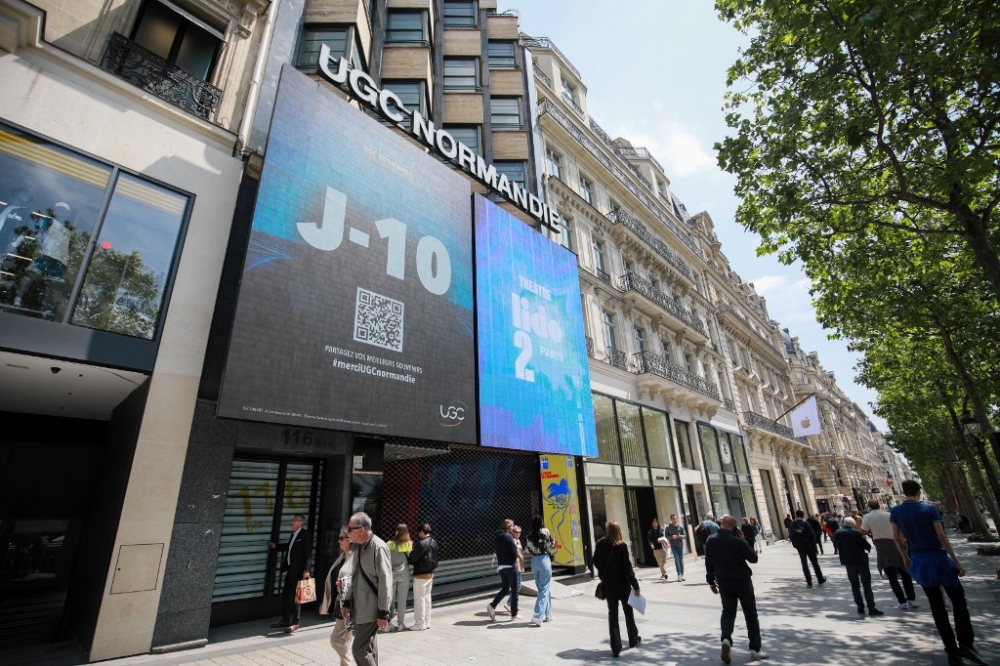 Pedestrians walk past the UGC Normandie cinema in the Champs-Elysées avenue in Paris, on June 3, 2024, which will be closed in June 2024 due to the falling visitor numbers. — AFP pic
