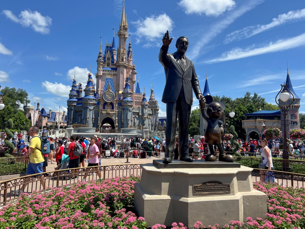 People gather at the Magic Kingdom theme park before the Festival of Fantasy parade at Walt Disney World in Orlando, Florida July 30, 2022. — Reuters pic  