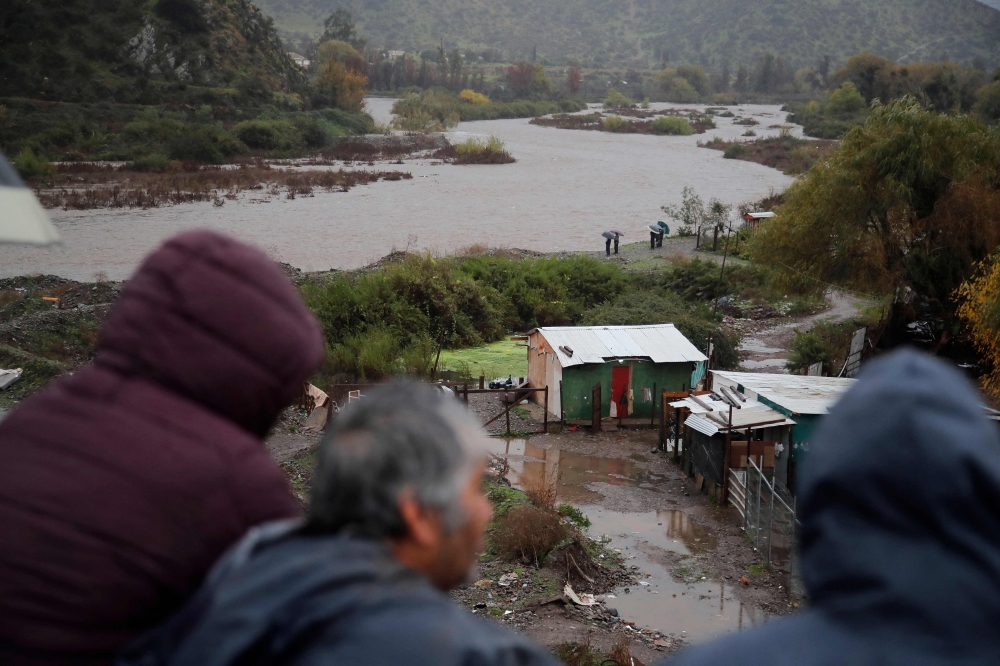 Heavy rains battered south and central Chile yesterday, killing one person and causing damage to hundreds of homes as authorities declared a state of catastrophe in five regions of the South American country. — AFP pic