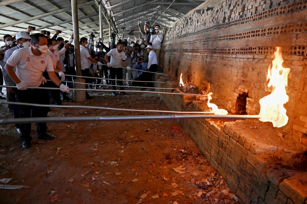 Officials burn seized drugs during a destruction ceremony to mark the UN’s ‘International Day against Drug Abuse and Illicit Trafficking’ in Phnom Penh June 14, 2024. — AFP pic