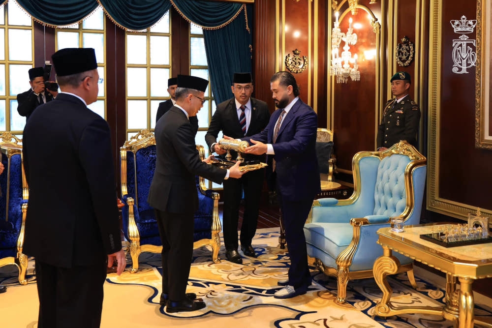 The Regent of Johor Tunku Mahkota Ismail receives the Instrument of Royal Invitation presented by Communications Minister Fahmi Fadzil at Balai Mengadap, Istana Bukit Serene, Johor Baru, June 14, 2024. — Picture from Facebook/HRH Crown Prince of Johor   