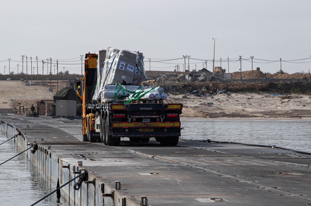 A truck carries humanitarian aid across Trident Pier, a temporary pier to deliver aid, off the Gaza Strip, amid the ongoing conflict between Israel and the Palestinian Islamist group Hamas, near the Gaza coast, May 19, 2024. — US Army Central handout pic via Reuters 