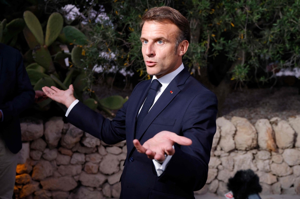 French President Emmanuel Macron gestures as he speaks to the media during the G7 Summit at the Borgo Egnazia resort in Savelletri, near Bari, Italy June 14, 2024. — AFP pic