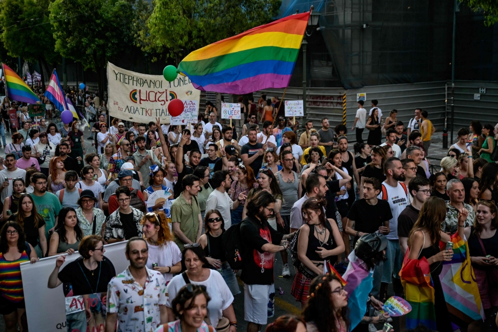 Thousands of people celebrated Pride in central Athens yesterday as LGBTQ associations demanded that authorities instigate greater change despite passing a landmark reform legalising same-sex marriage and adoption. — AFP pic