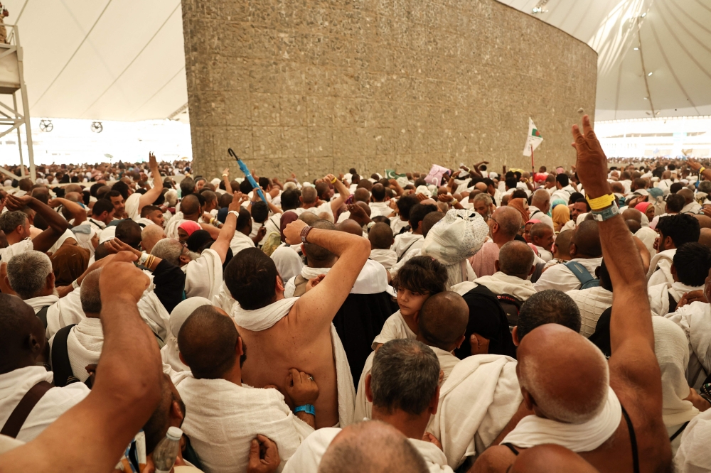 Pilgrims perform the last major ritual of the haj, the ‘stoning of the devil’, in western Saudi Arabia today, as Muslims the world over celebrate the Aidiladha holiday. — AFP pic