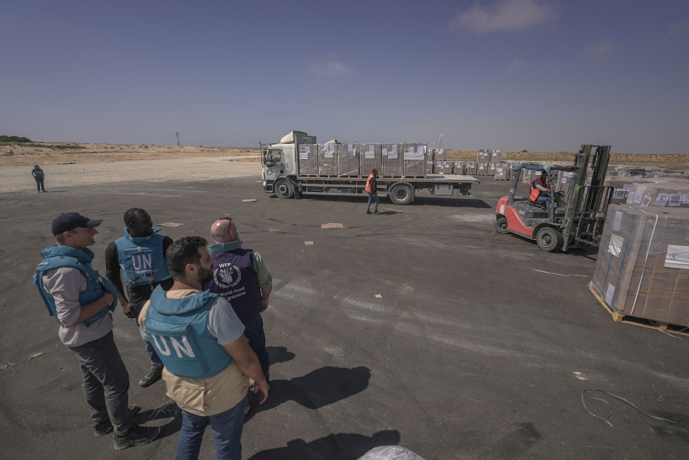 World Food Programme personnel keep watch on a food aid distribution operation at the Zikim crossing. — Reuters pic/World Food Programme