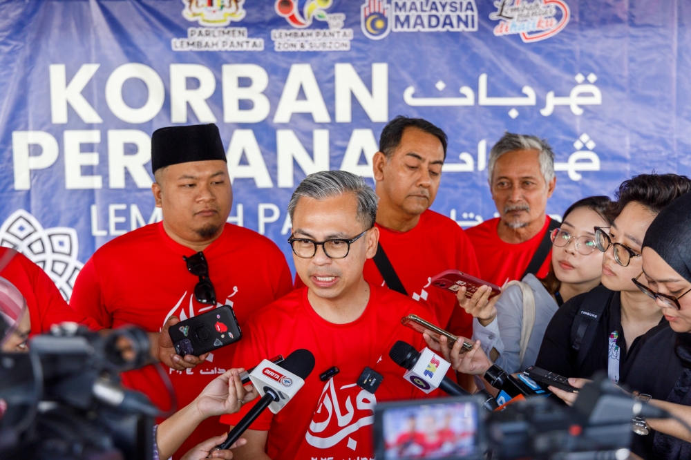 Communications Minister Fahmi Fadzil speaks to reporters at the 'Korban Perdana Lembah Pantai' event in Kuala Lumpur June 17, 2024. — Picture by Firdaus Latif