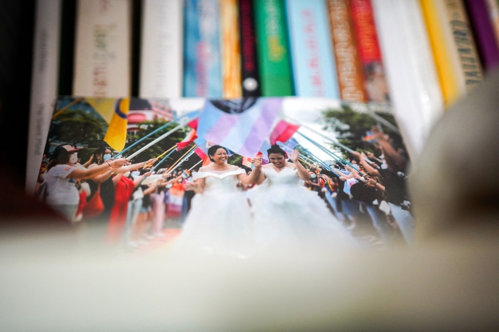 A picture showing Vorawan Ramwan and Anticha Sangchai wearing wedding dresses in a Pride parade. — Reuters pic