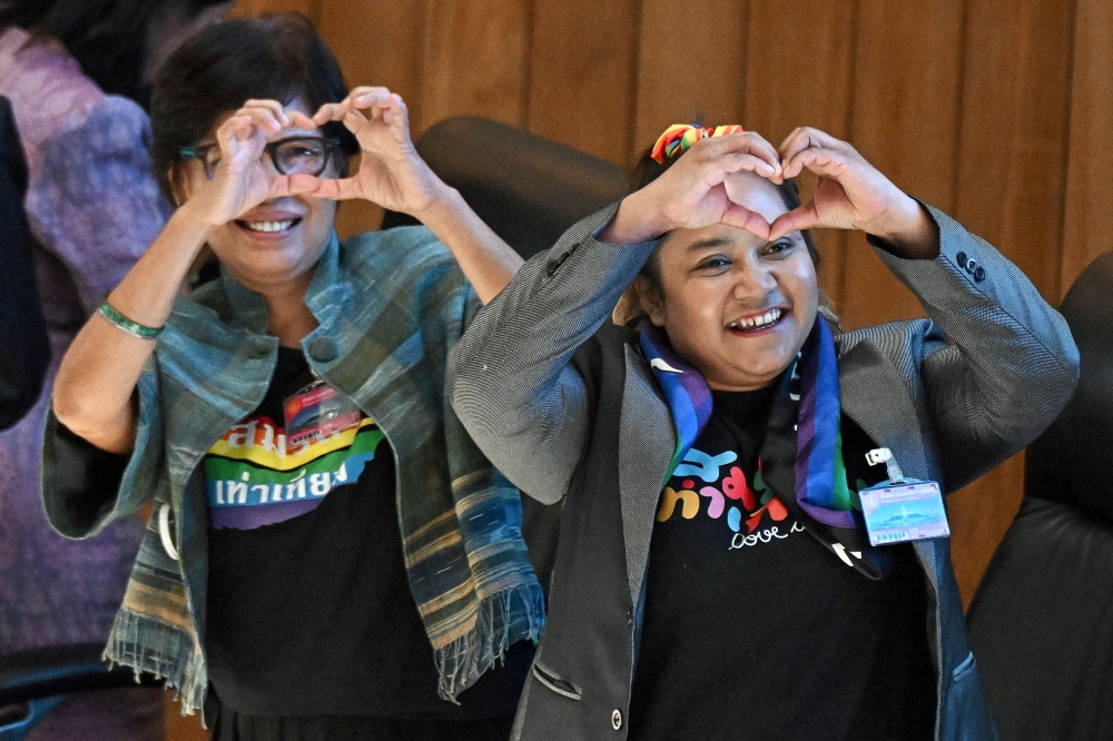 Activists from the LGBTQ community celebrate after the passing of the final senatorial vote on the same sex marriage bill at the Thai Parliament in Bangkok on June 18, 2024. — AFP pic