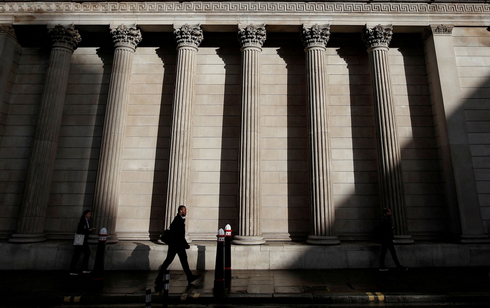 A commuter walks past the Bank of England, in London, Britain, September 26, 2022. — Reuters file pic