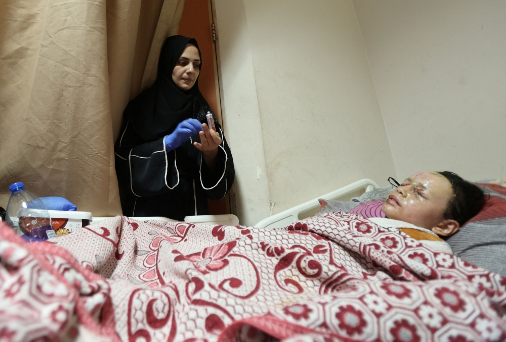  A wounded Palestinian girl, Hanan Akel, who suffered burn injuries in an Israeli strike, lies on a bed at Al-Aqsa Martyrs Hospital, amid the Israel-Hamas conflict, in Deir Al-Balah, in central Gaza Strip June 18, 2024. — Reuters pic