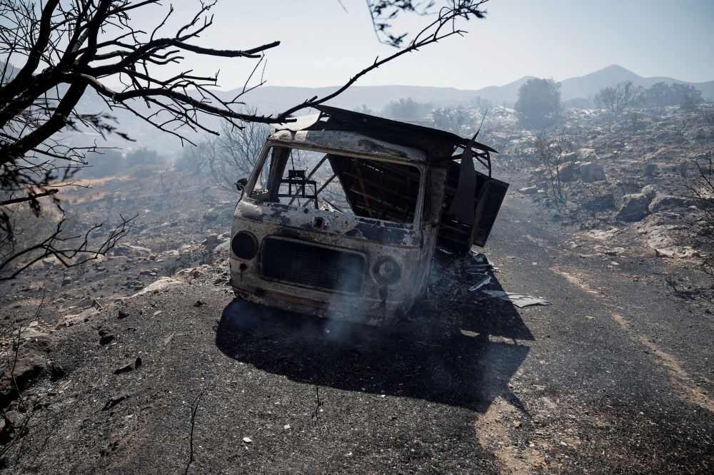 A fire near Athens fanned by strong winds and high temperatures has led to the evacuation of two villages, Greek authorities said yesterday, pointing the finger at arsonists. — Reuters pic