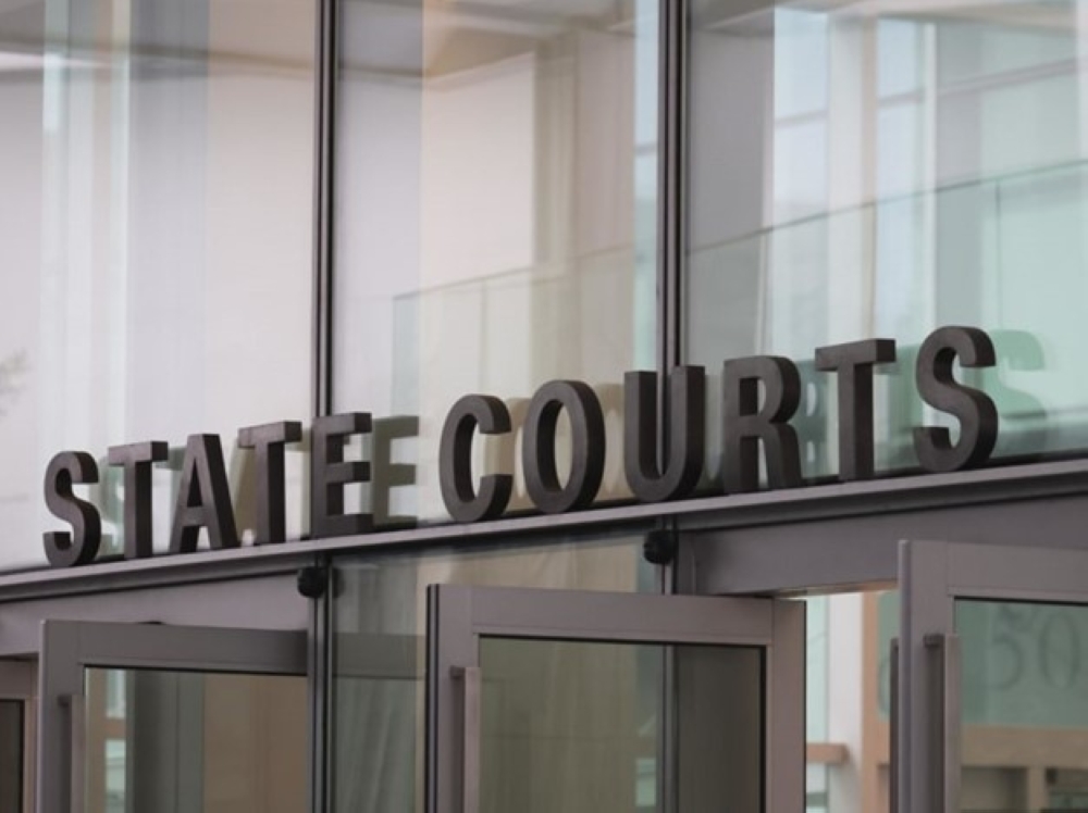 Two women were charged today with starting a fire outside a public housing unit along Canberra Road and planning to set a second fire. — TODAY pic