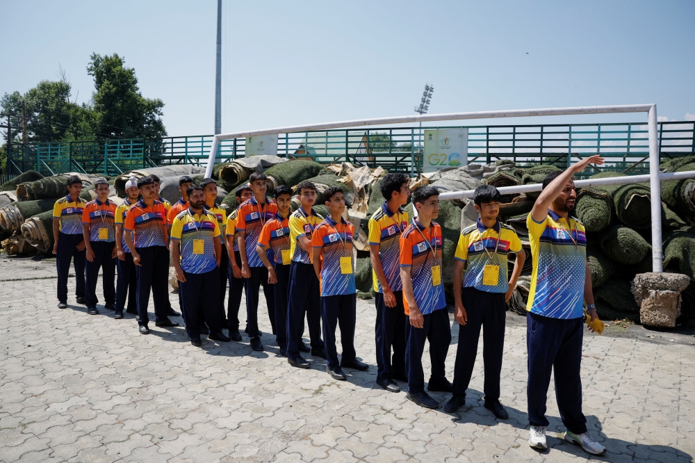 School children stand in a queue to meet Indian Prime Minister Narendra Modi on the day of Modi's visit on International Yoga Day at Sher-i-Kashmir International Conference Centre in Srinagar June 20, 2024. — Reuters pic
