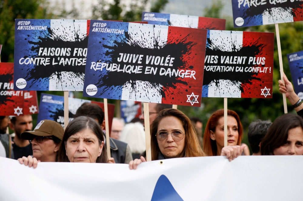 People attend a demonstration against anti-Semitism at the Place de la Bastille after three teenagers aged 12 to 13 were indicted in Courbevoie, accused of rape and anti-Semitic violence against a 12-year-old girl, in Paris, France, June 20, 2024. — Reuters pic
