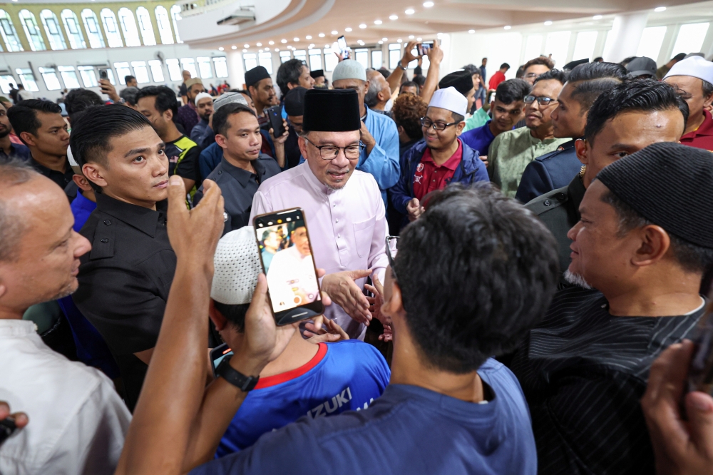 Prime Minister Datuk Seri Anwar Ibrahim mingles with the congregation after performing Friday prayers at the Tun Abdul Aziz Mosque in Kuala Lumpur, June 21, 2024. — Bernama pic 