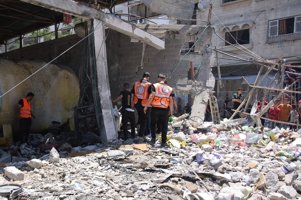 Gaza municipality employees and some civil defence workers inspect the site following the Israeli military bombardment of the Gaza Municipality garage on al-Wahda Street, in the al-Daraj neighbourhood in Gaza City on June 21, 2024. ― AFP pic