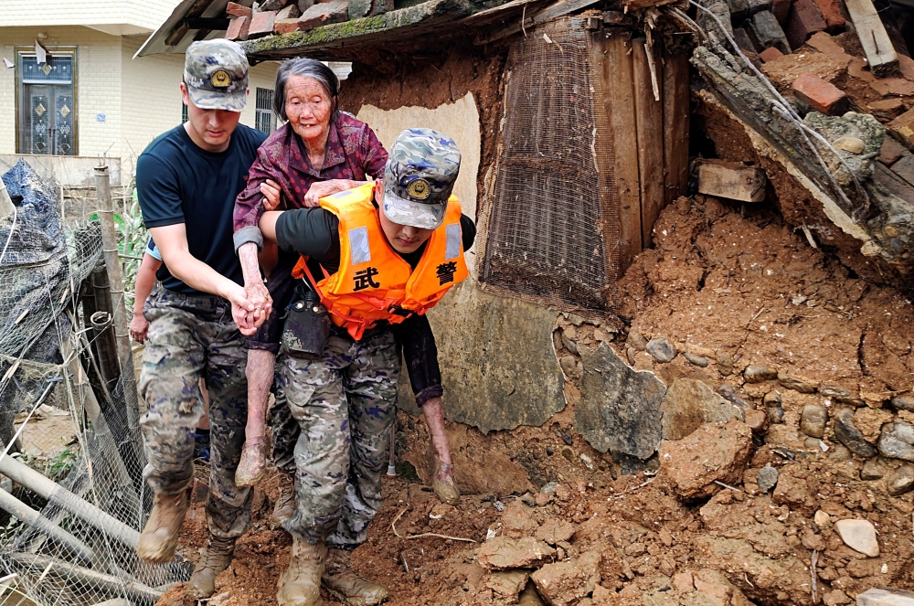 Paramilitary police officers help transfer an elderly resident affected by the flood following heavy rainfall in Wuping county of Longyan, Fujian province, China June 17, 2024. ― cnsphoto via Reuters