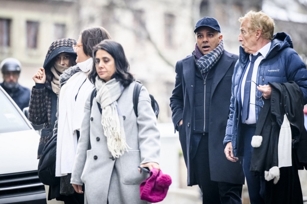 Indian-Swiss billionaire family members Namrata Hinduja (left) and Ajay Hinduja (second from right) arrive at the Geneva’s courthouse with their lawyers Yael Hayat (centre) and Robert Assael (right) at the opening day of their trial for human trafficking on January 15, 2024. — AFP pic