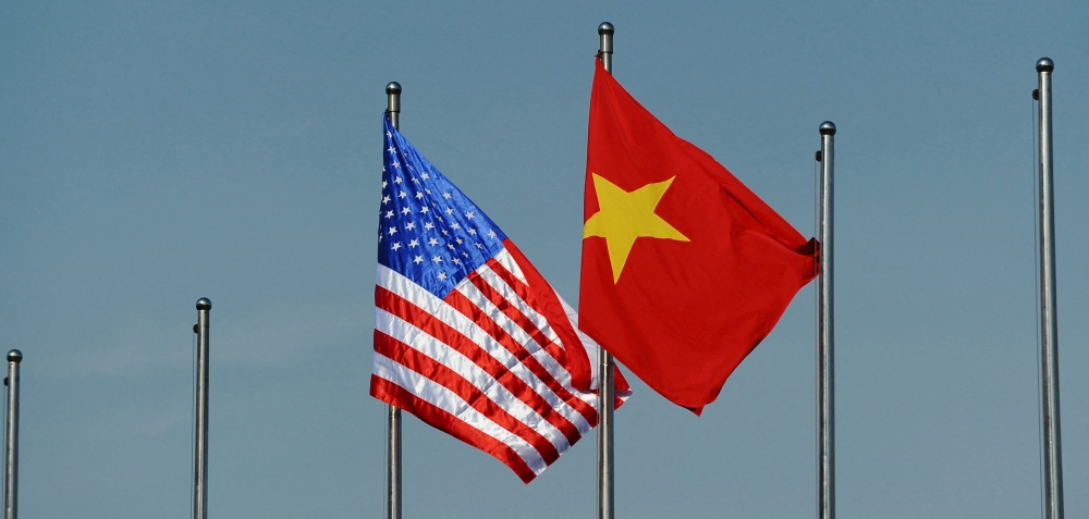 File photo of the US flag (left) flutters next to the Vietnamese flag at the Defence Ministry in Hanoi, Vietnam June 1, 2015. — Reuters pic