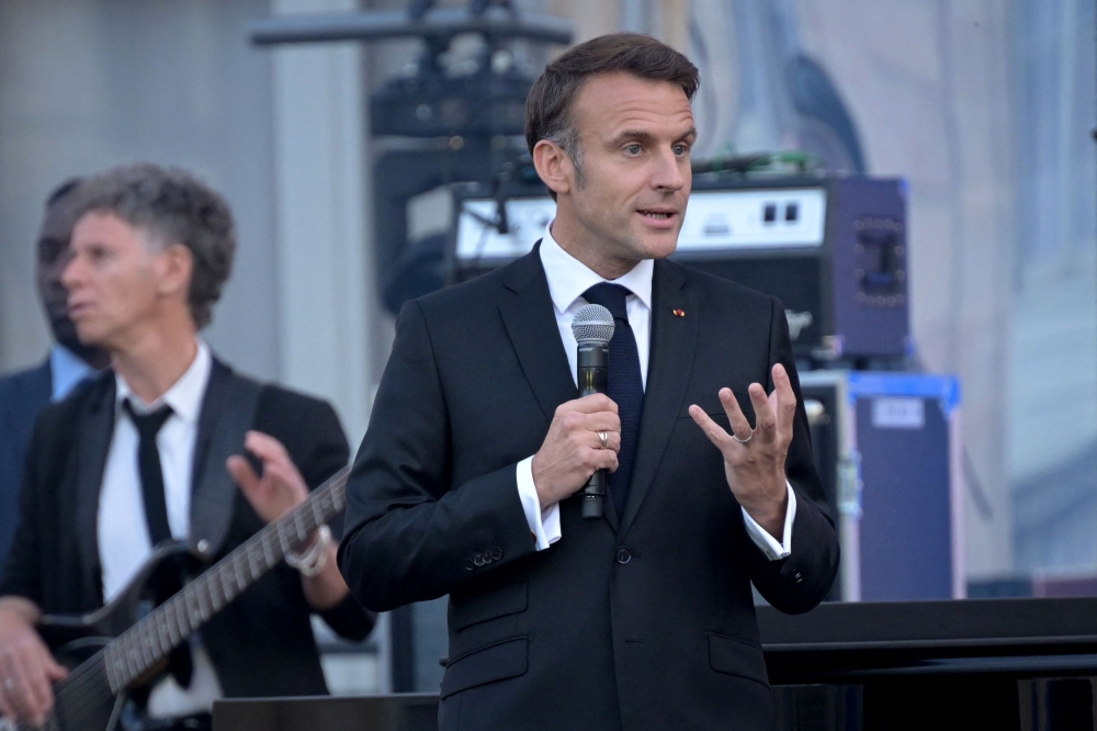 France’s President Emmanuel Macron speaks during the annual ‘Fete de la musique’ one-day music festival in the courtyard of the Elysee presidential palace in Paris on June 21, 2024. — AFP pic
