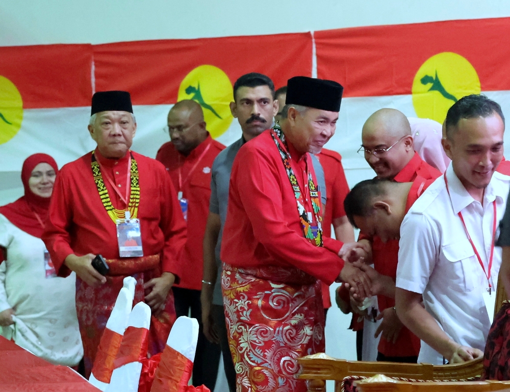 Deputy Prime Minister and Umno president Datuk Seri Ahmad Zahid Hamidi, accompanied by Sabah Umno chief Datuk Seri Bung Moktar Radin, shakes hands with Umno representatives when they arrive to officiate the Kimanis Division Umno Meeting in Kota Kinabalu June 22, 2024. — Bernama pic