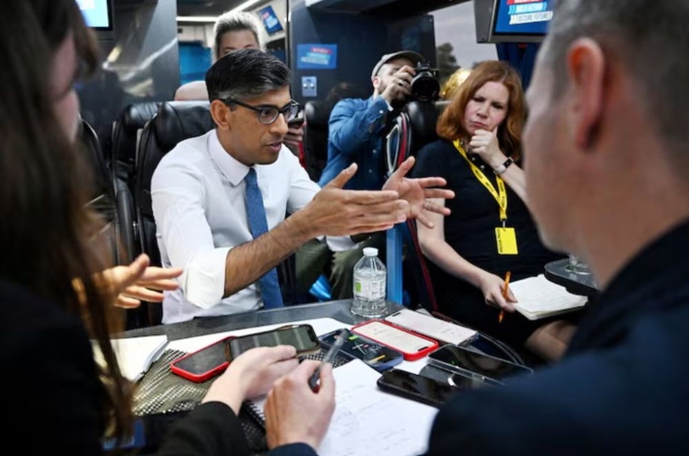 British Prime Minister Rishi Sunak speaks to journalists on the campaign bus following the launch of the Welsh Conservatives General Election manifesto on June 21, 2024, near Rhyl, Britain. — Pool picture via Reuters