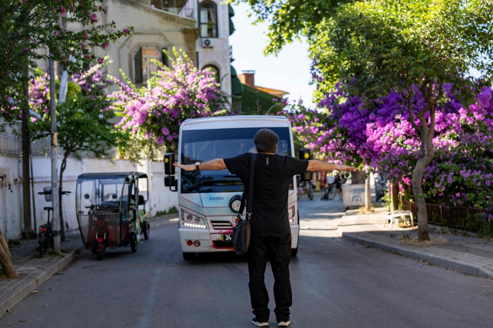 Lawyer and head of the Association of Friends of the Island Ibrahim Aycan, 47, is protesting to stop new minibuses on the island of Buyukada, in Istanbul on June 20, 2024. — AFP pic