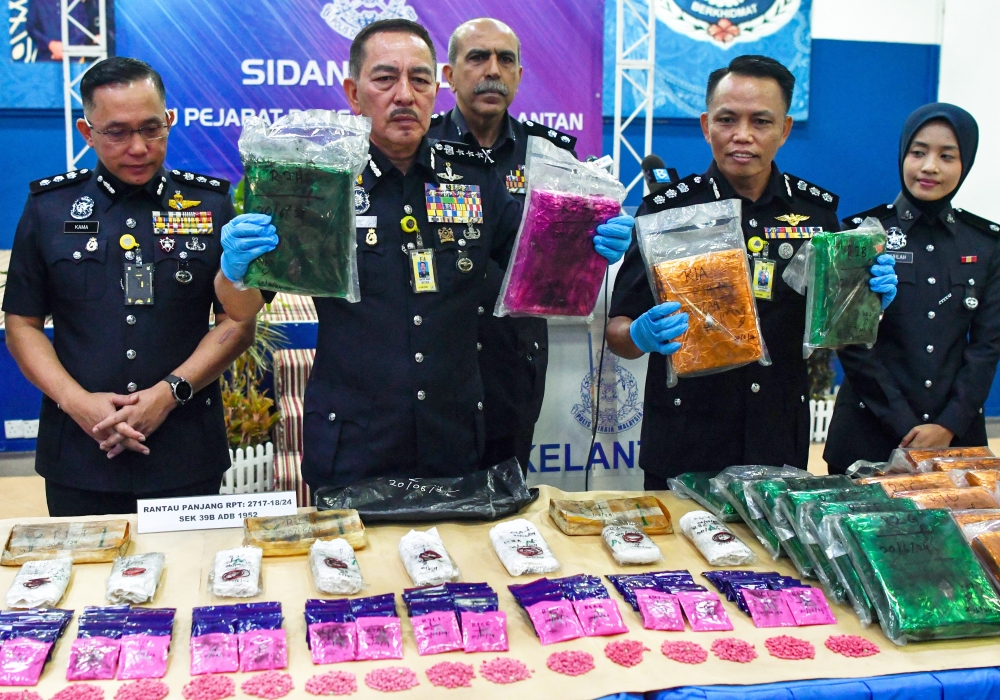 Kelantan police chief Datuk Muhammad Zaki Harun (2nd left) and other officers show part of the drugs seized in a raid in a special media conference at the Kelantan contingent police headquarters June 23, 2024. — Bernama pic