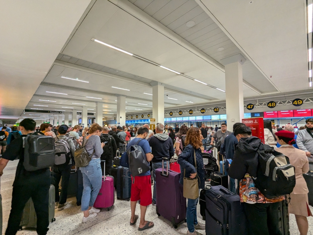 Passengers queue at the airport following a power cut, in Manchester, Britain June 23, 2024, in this picture obtained from social media. — Courtesy of Chris Shaw via Reuters