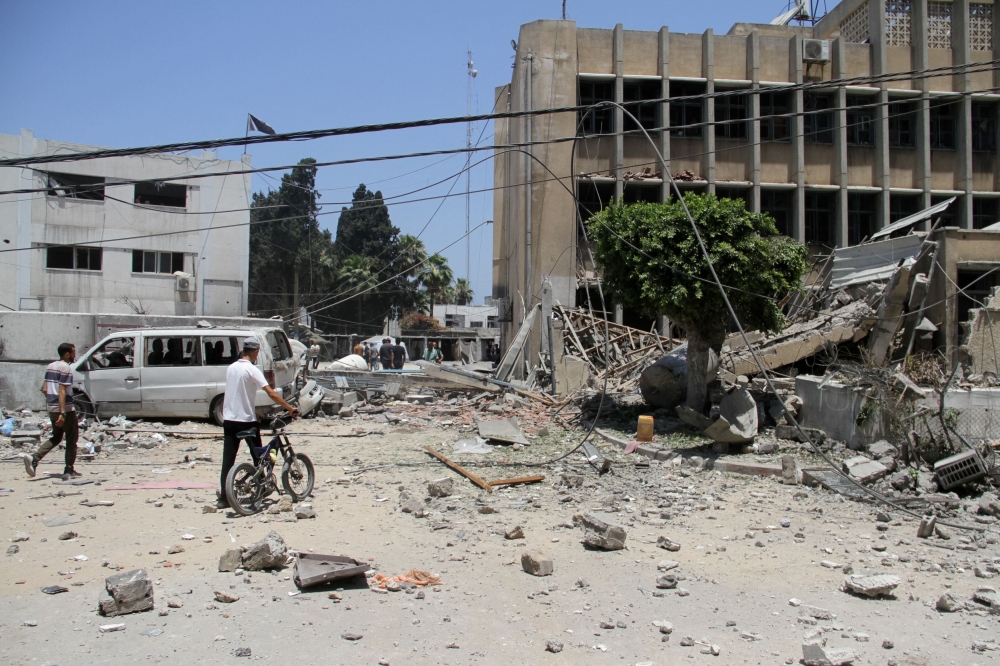 Palestinians search for casualties outside the headquarters of UNRWA (United Nations Relief and Works Agency) following an Israeli strike, amid the Israel-Hamas conflict, in Gaza City, June 23, 2024. — Reuters pic