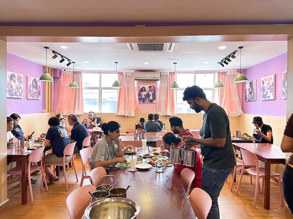 The place may be small but it's cosy with the purple pink hues and artwork featuring the couple who run this eatery