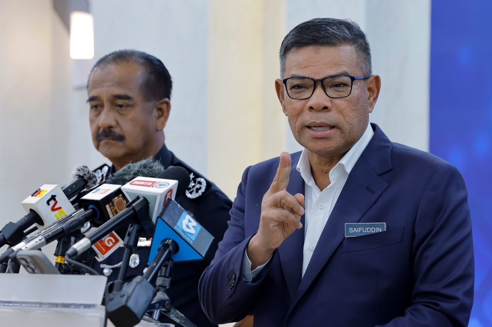 Home Minister Datuk Seri Saifuddin Nasution Ismail and Inspector-General of Police Tan Sri Razarudin Husain (left) attend a press conference at the Home Ministry in Putrajaya June 24, 2024. — Bernama pic