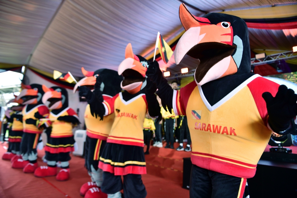 The official mascots for the Malaysian Games (Sukma) Satria (male) and Satrina (female) enliven the atmosphere during the Kuching Division Baton Run opening ceremony in conjunction with Sukma and Para Sukma XXI at the Kuching Riverbank June 24, 2024. — Bernama pic