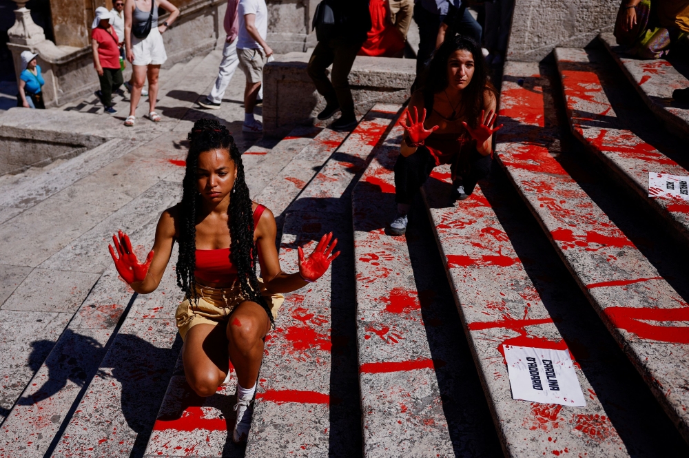 Campaigners highlighting violence against women spread red paint across Rome’s famous Spanish Steps yesterday, in a protest the local authority said did not cause permanent damage. — Reuters pic