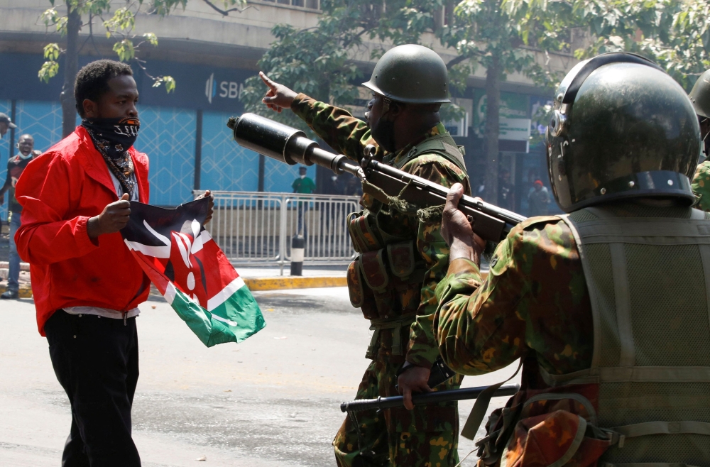 Police officers argue with a protestor during a demonstration yesterday. — Reuters pic