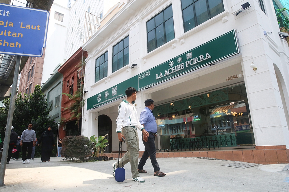 People walking past the front of La Achee Porra.